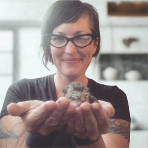 Andee Bingham holding newborn gray kitten