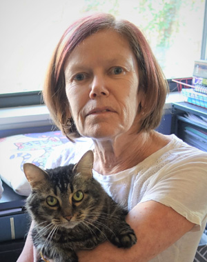 Portrait of Sheilah Robertson, holding a gray tabby cat