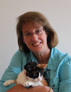 Portrait of Rosemarie Crawford holding a calico cat.